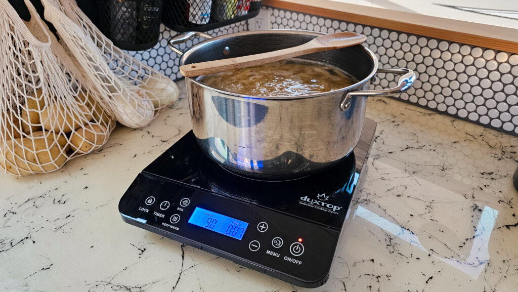 portable induction cooktop used in a skoolie kitchen